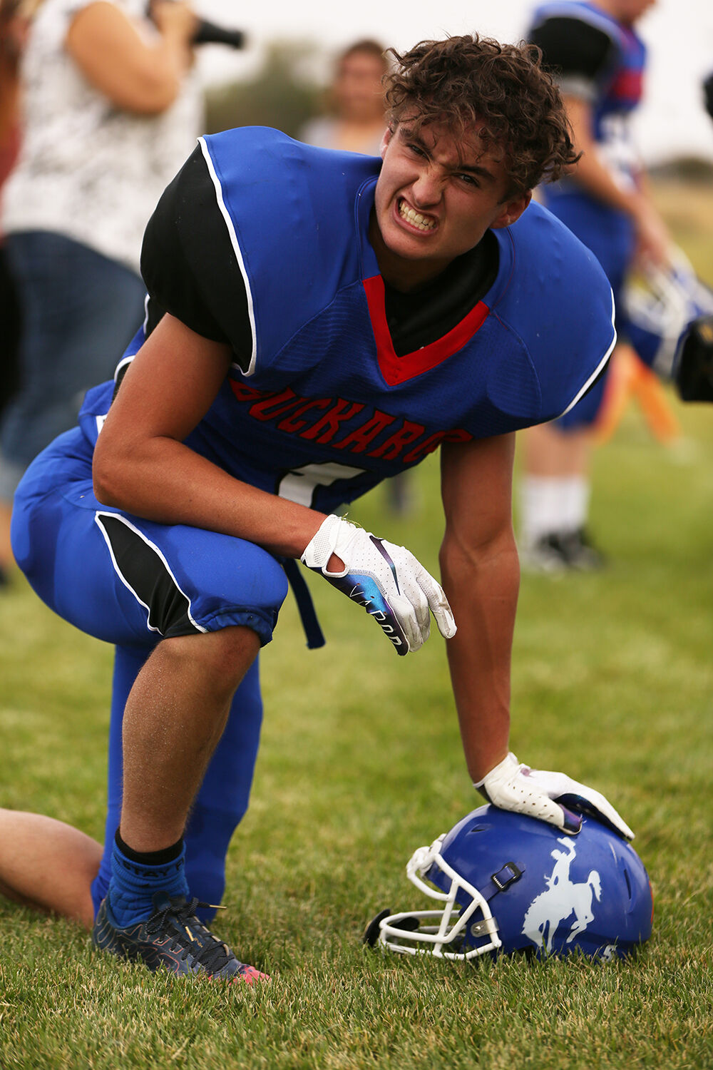 Dylan Fauber kneels after coming off the field after a play